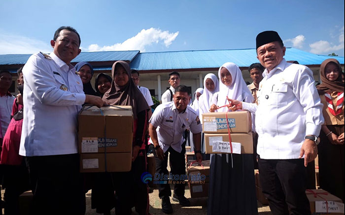 Foto : Bupati Muaro Jambi, Dr. Bambang Bayu Suseno, bersama Gubernur Jambi, Al Haris, menyerahkan langsung bantuan program Dumisake Pendidikan kepada 466 siswa kurang mampu di Lapangan SMA Negeri 3 Desa Sebapo, Kecamatan Mestong, Rabu 29 Oktober 2025 (Dok Pemkab Muaro Jambi)